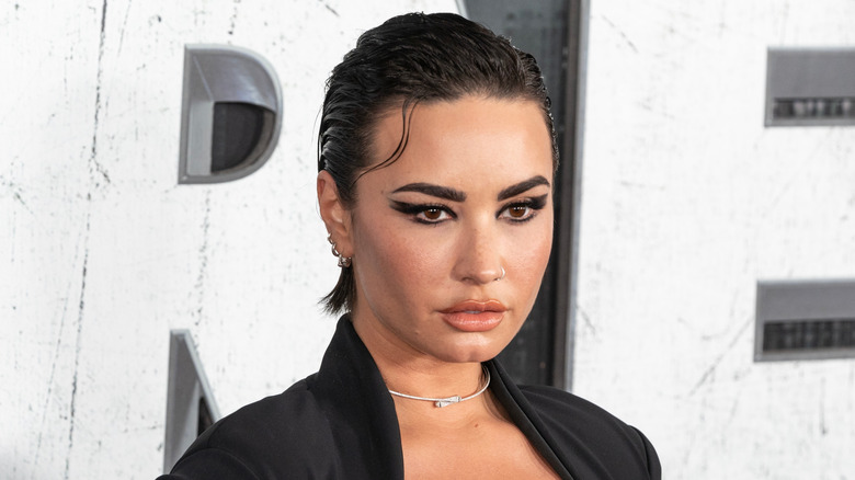 Demi Lovato with slicked back hair and dramatic eye makeup