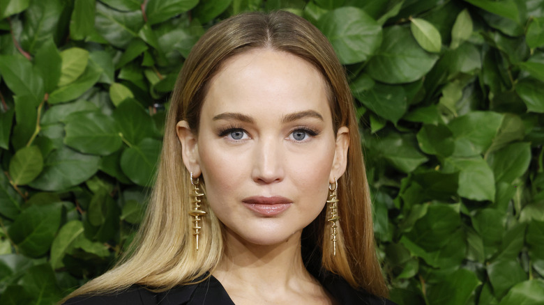 Jennifer Lawrence posing against leafy background