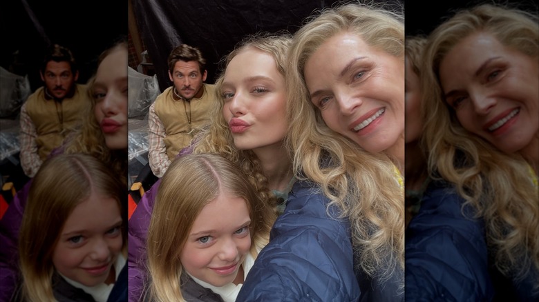 Michelle Pfeiffer smiling with Amiah Miller, Alaina Pollack, and Kevin Zegers