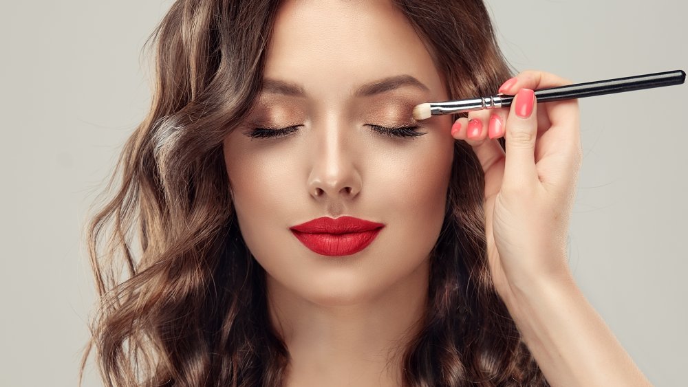 A woman having her makeup done