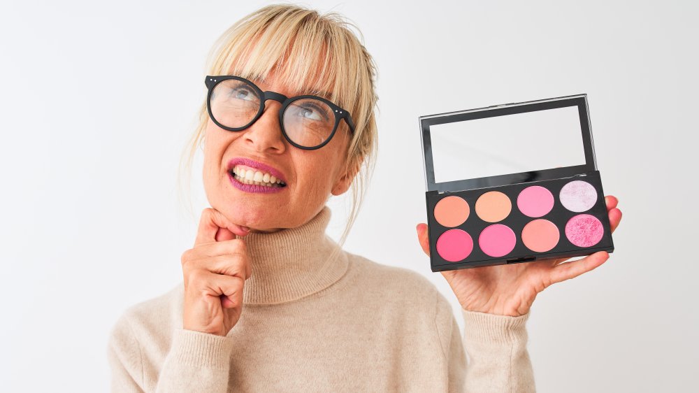Older woman with makeup palette