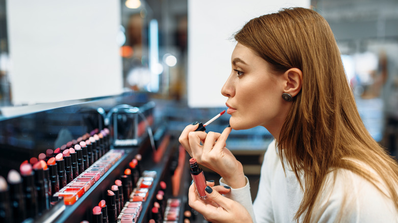 woman applying lipstick