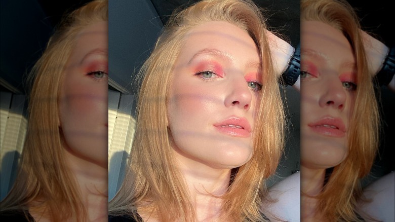 Woman with strawberry blonde hair with pink eyeshadow