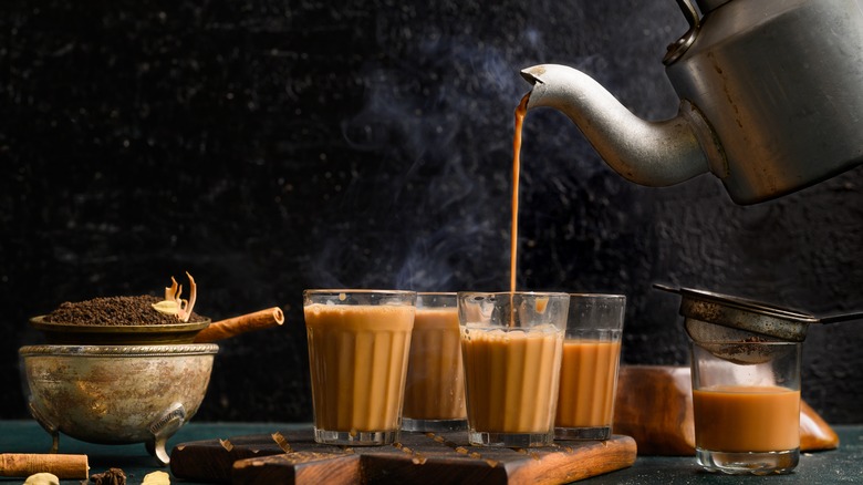 Cups of chai and cinnamon sticks