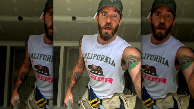 Kenny Brain wearing toolbelt