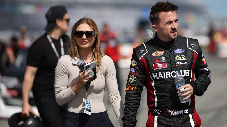 Paige Price Muniz beige top holding hands with Frankie Muniz in a racing suit