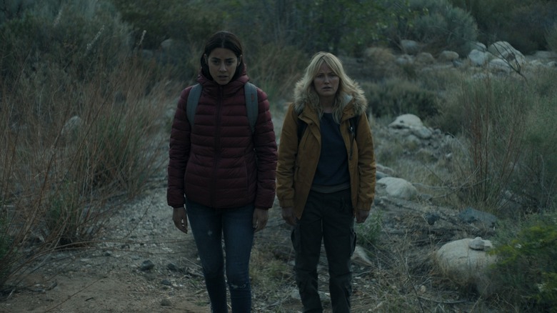 Lorenza Izzo and Malin Akerman walking together in The Aviary