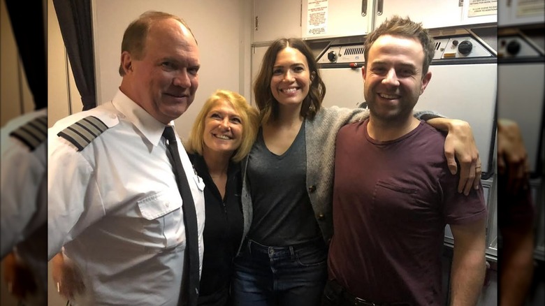 Donald Moore, Mandy Moore and Taylor Goldsmith posing on a plane with a loved one