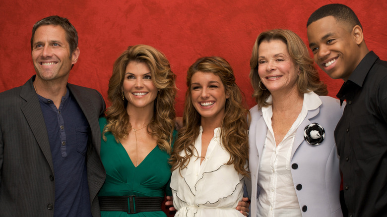 (l-r): "90210" stars Rob Estes, Lori Loughlin, Shenae Grimes, Jessica Walters, and Tristan Wilds smiling and posing together.