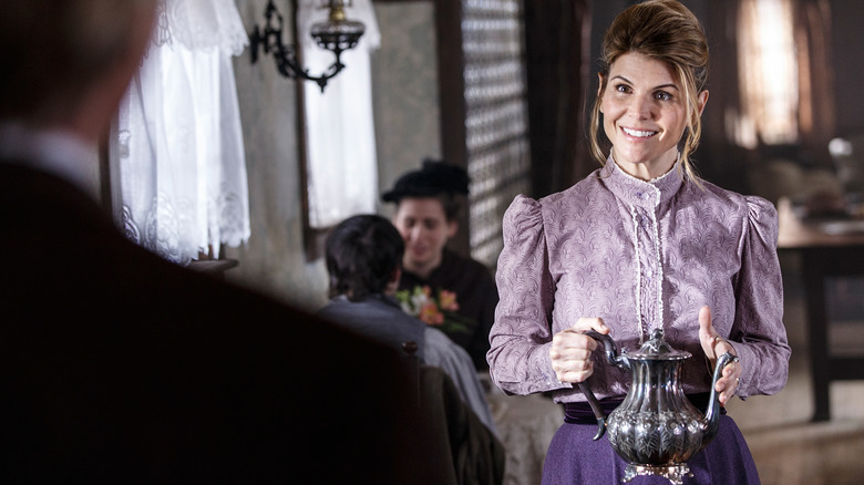 Lori Loughlin smiling and holding a tea kettle as Abigail Stanton on "When Calls the Heart."