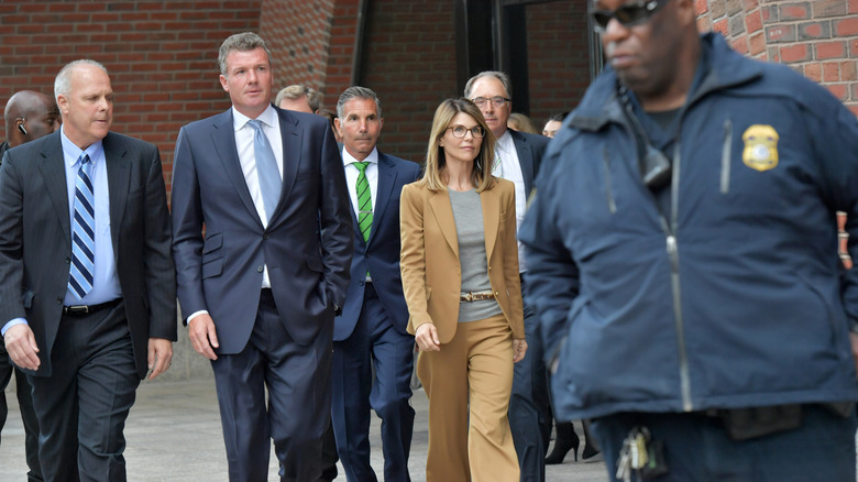 Lori Loughlin and Mossimo Giannulli walking into court with their legal team.