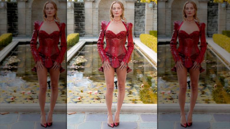 Margot Robbie in a red outfit with puff sleeves and cut-out bust
