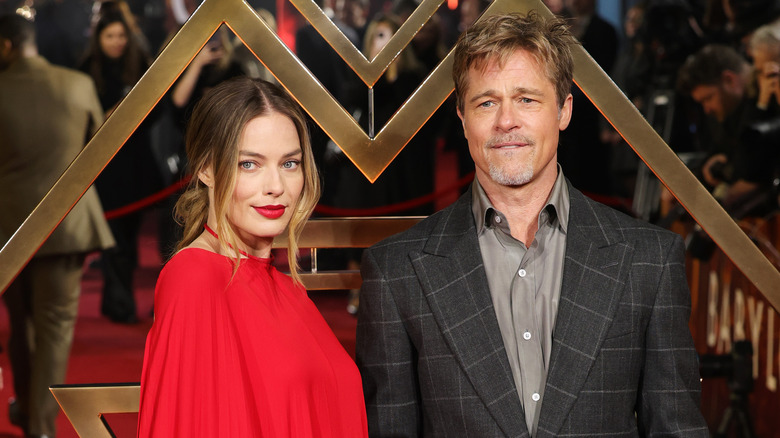 Margot Robbie and Brad Pitt posing at Babylon premiere