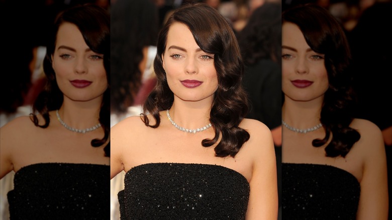 Margot Robbie chocolate brown hair, strapless black gown