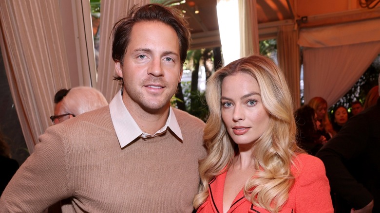 Tom Ackerley and Margot Robbie smiling