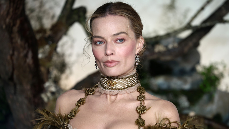 Margot Robbie pictured at a Wuthering Heights premiere in 2026, wearing an intricate green dress with her hair up