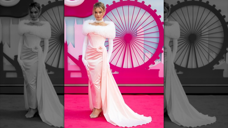 Margot Robbie at the "Barbie" European premiere wearing a pink gown with fluffy white ruff and silver heels