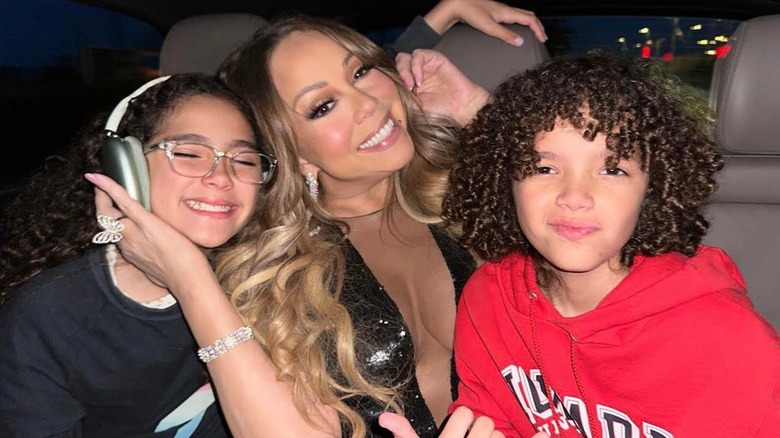 Mariah Carey and twins smiling in car