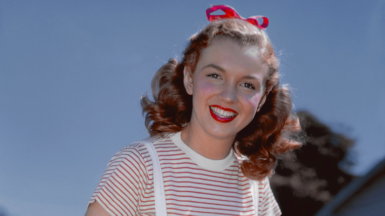 Marilyn Monroe in 1946 wearing a red-and-white striped shirt and red bow