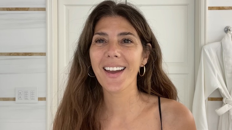 Marisa Tomei smiling and wearing hoop earrings