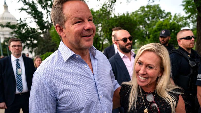 Brian Glenn and Marjorie Taylor Greene smile by the Capitol