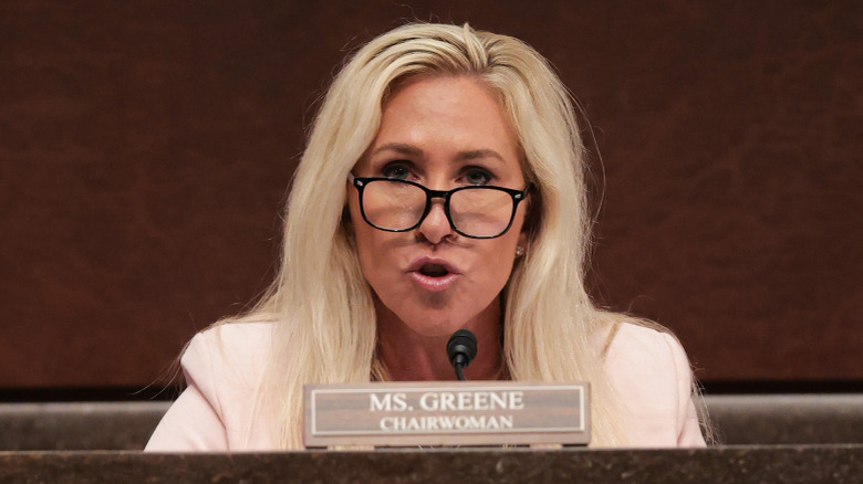 Marjorie Taylor Greene speaking into microphone
