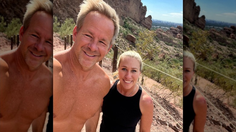 A shirtless Brian Glenn poses next to Marjorie Taylor Greene on a hike (2025)