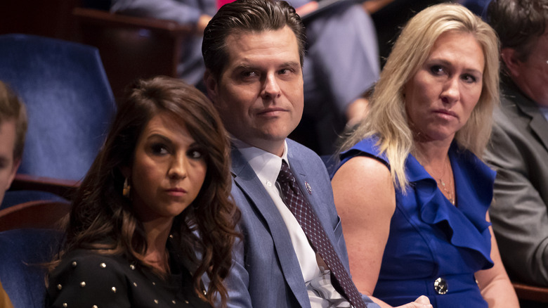 Lauren Boebert and Marjorie Taylor Greene seated on either side of Matt Gaetz