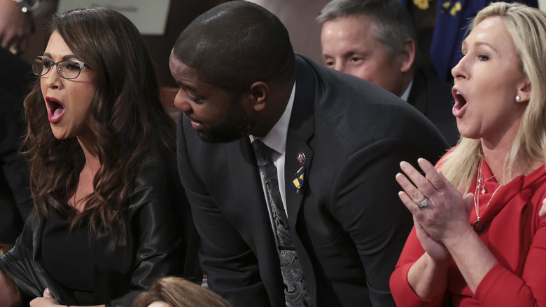 Lauren Boebert and Marjorie Taylor Greene heckling President Joe Biden while a colleague tries to intervene