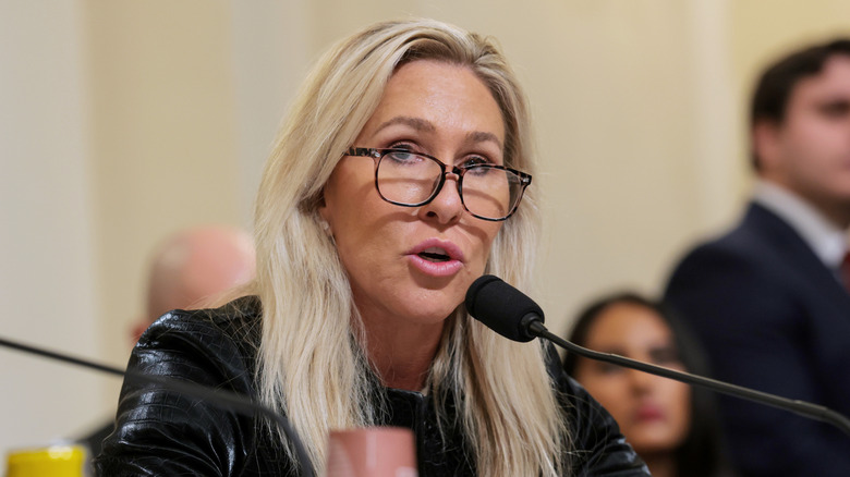 Marjorie Taylor Greene speaking into microphone