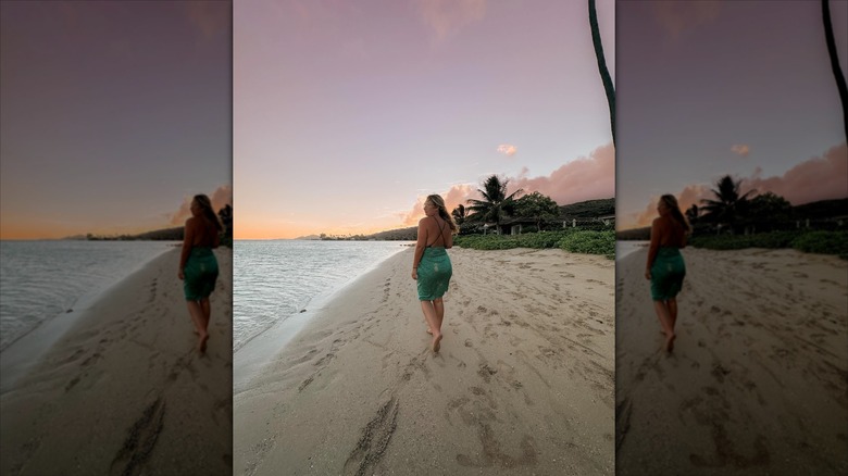 Lauren Greene Sanders looking over her shoulder on a beach.