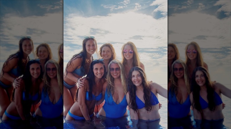 Lauren Greene Sanders in a bathing suit in the ocean with a group of friends.