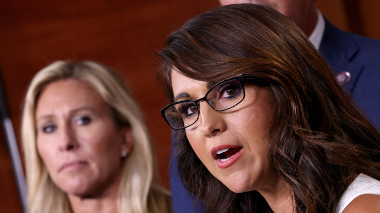 Marjorie Taylor Greene looking at Lauren Boebert while she speaks