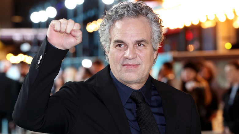 Mark Ruffalo lifting his fist into the air at a movie premiere