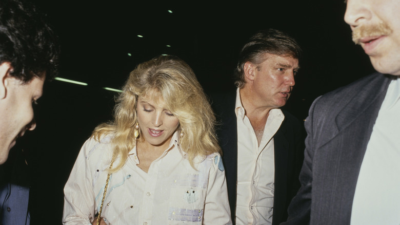 Marla Maples and Donald Trump walking at an event in the 1990s.