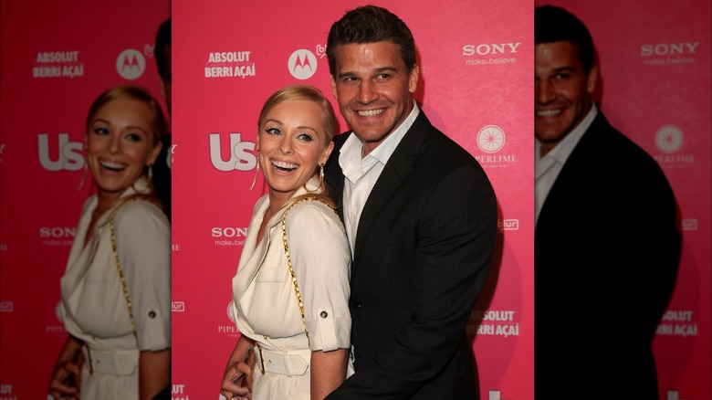 David Boreanaz embracing Jaime Bergman while both laugh and smile.