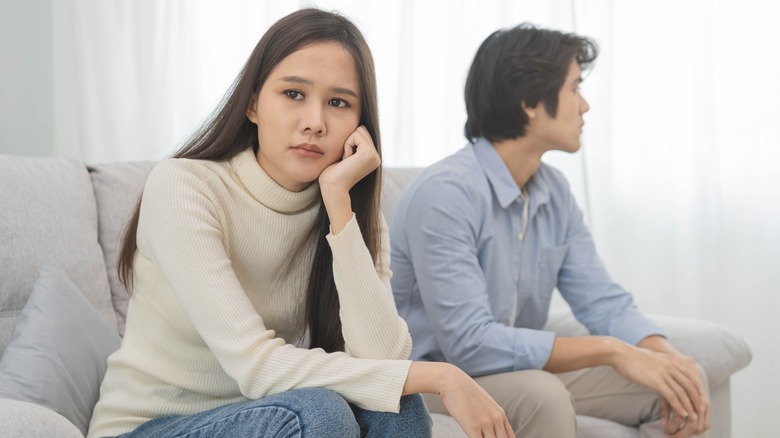 stressed couple on sofa