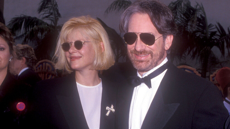 Steven Spielberg and Kate Capshaw smiling in sunglasses
