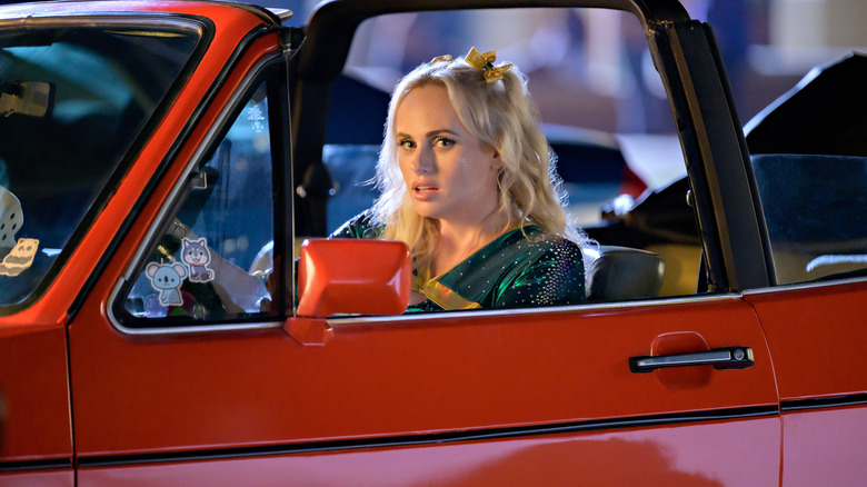 Rebel Wilson in a red car 