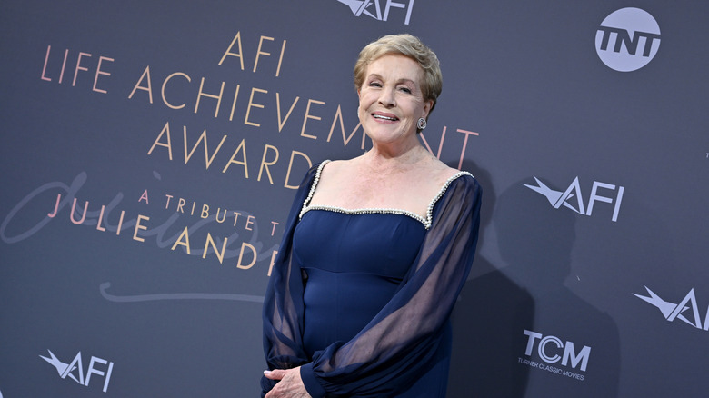 Julie Andrews smiles in a blue dress