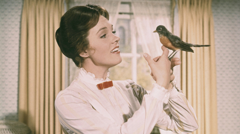 Julie Andrews holds a bird in a scene from Mary Poppins