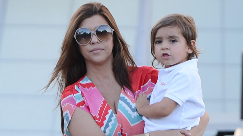 Kourtney Kardashian walks with Mason Disick