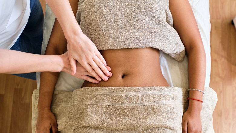 Woman receiving stomach massage 