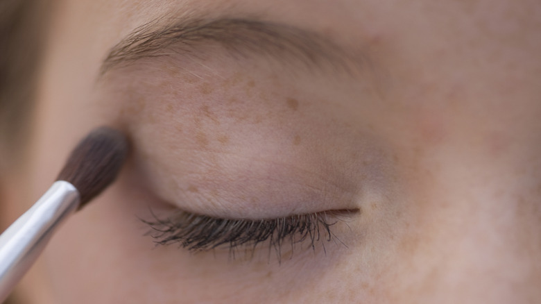 applying primer to eyelid