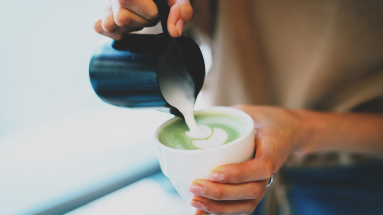 Barista making a green tea latte 