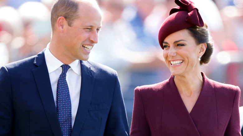 Prince William and Kate Middleton walking side by side, smiling