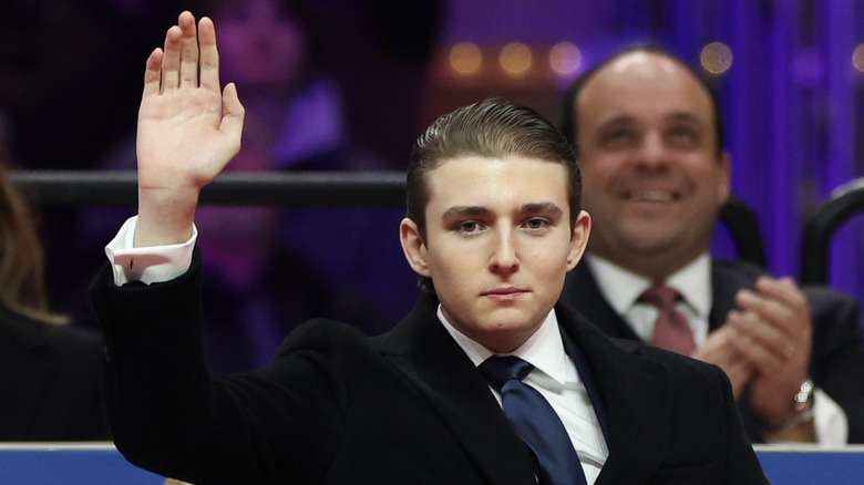 Barron Trump looking serious and waving