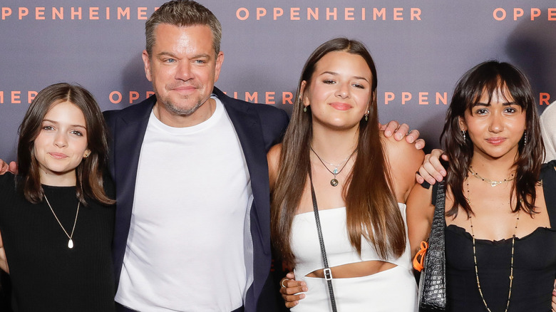 Matt Damon, Stella Damon, Gia Damon, and Alexia Barroso smiling at the premiere of "Oppenheimer"