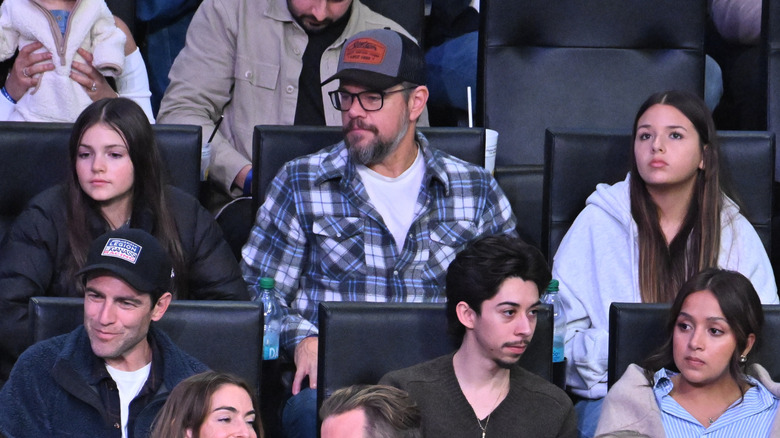 Matt Damon, Gia Damon, and Stella Damon watching a basketball game
