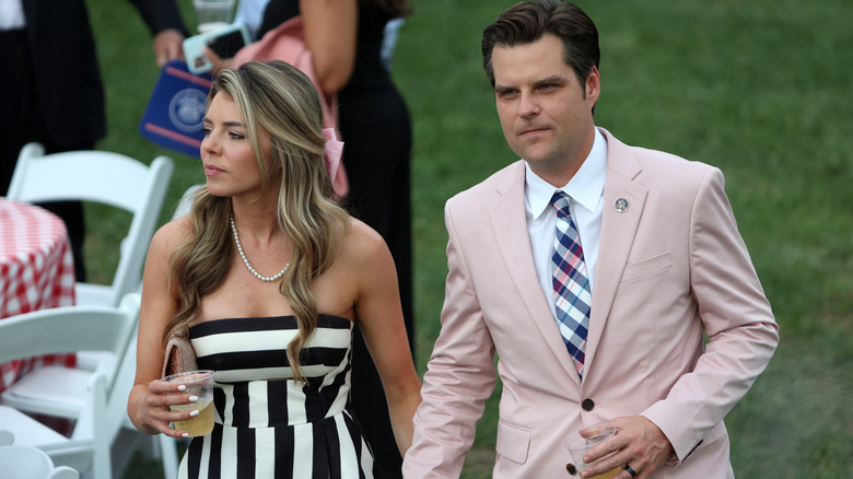 Ginger Luckey Gaetz and Matt Gaetz walking while holding hands